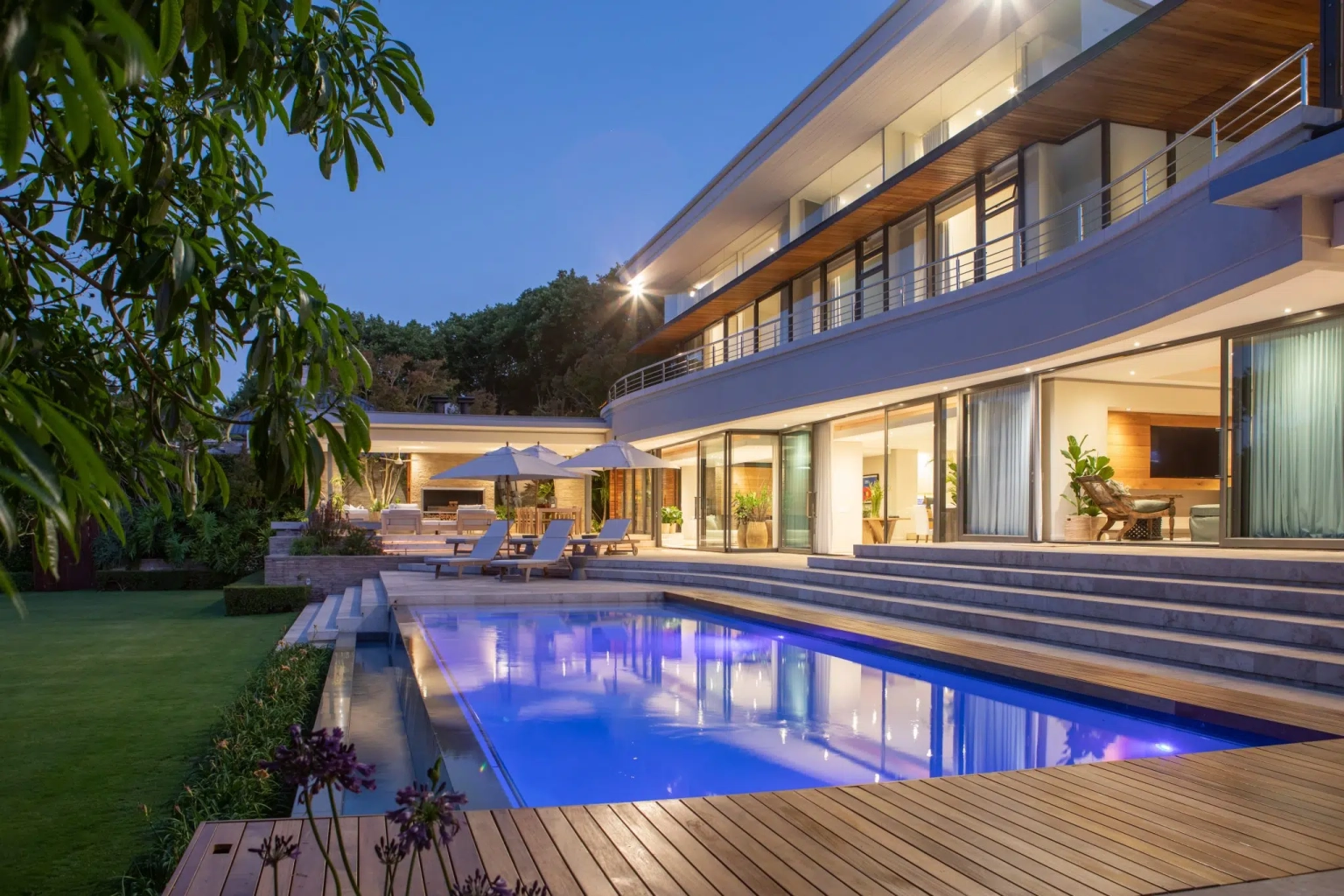 Makomo, Cape Town — a luxury villa and swimming pool at dusk