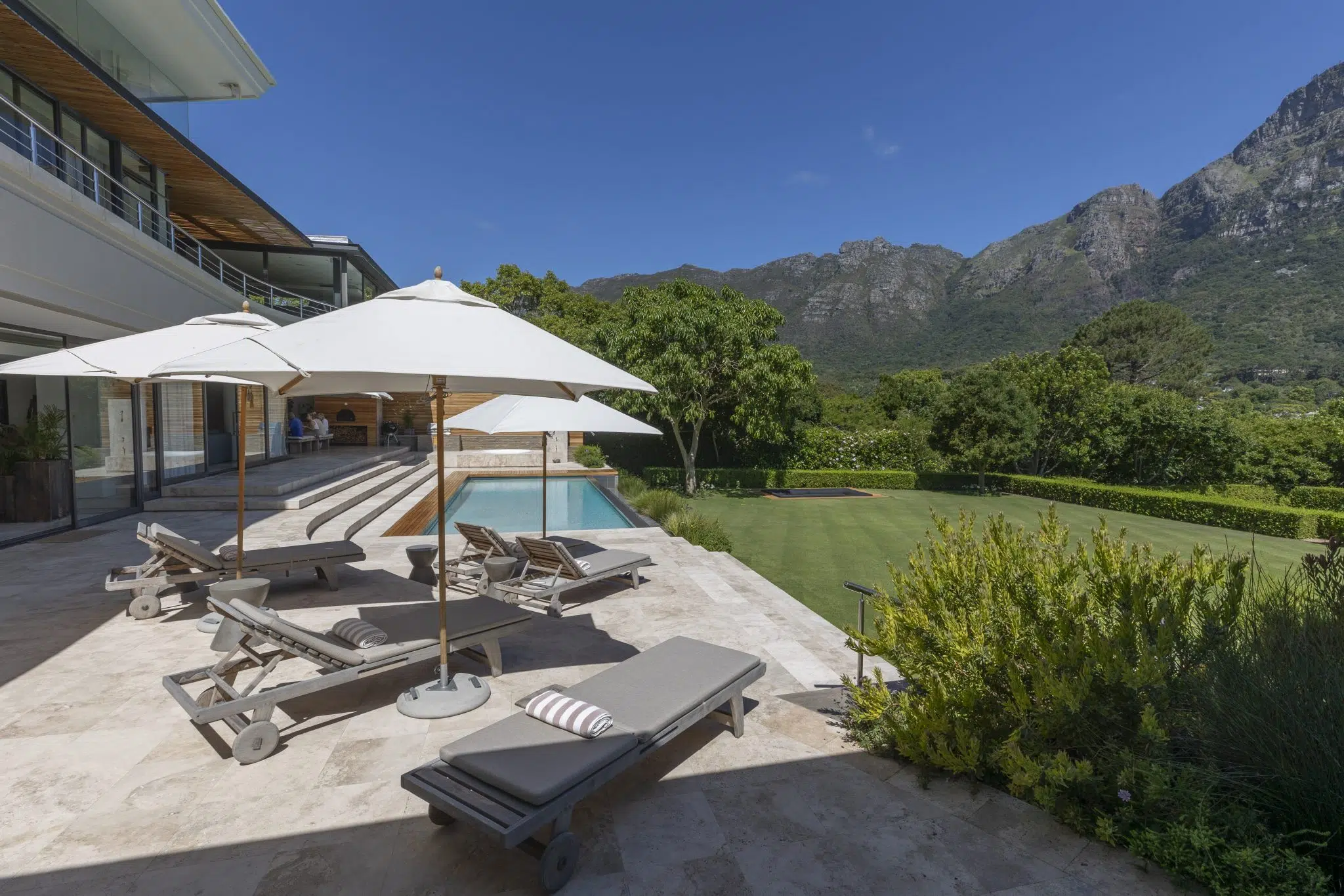 Sun loungers on a stone terrace with mountain views